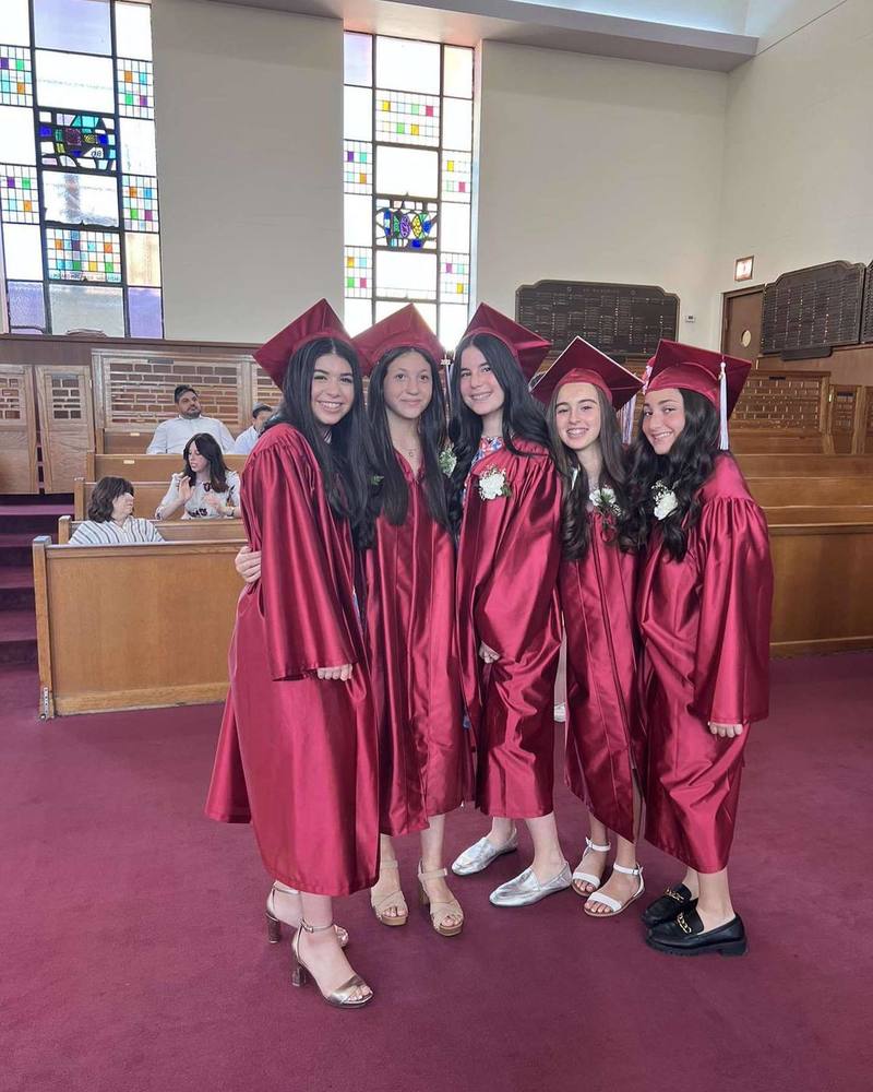 8th grade graduates in their caps and gowns