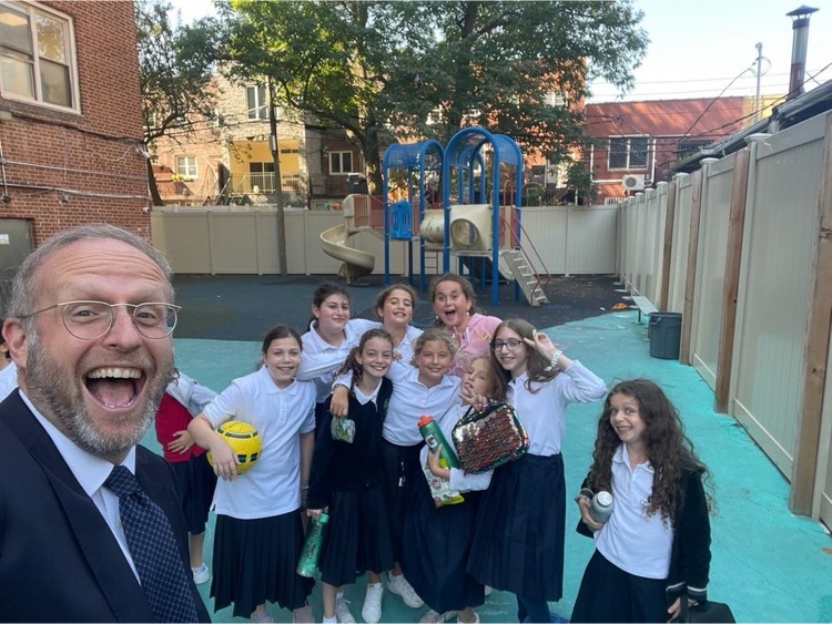 some girls with rabbi in playground 